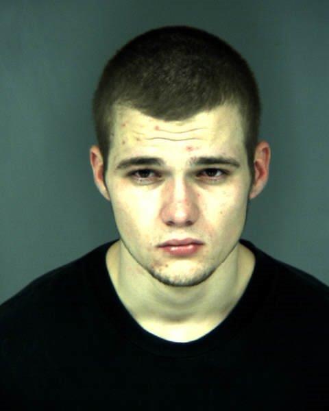 caucasian male, dark hair, wearing a black shirt